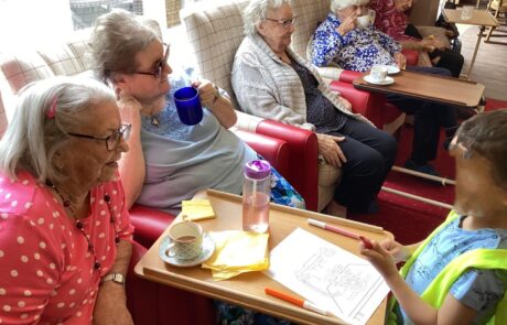 care home residents talking with children